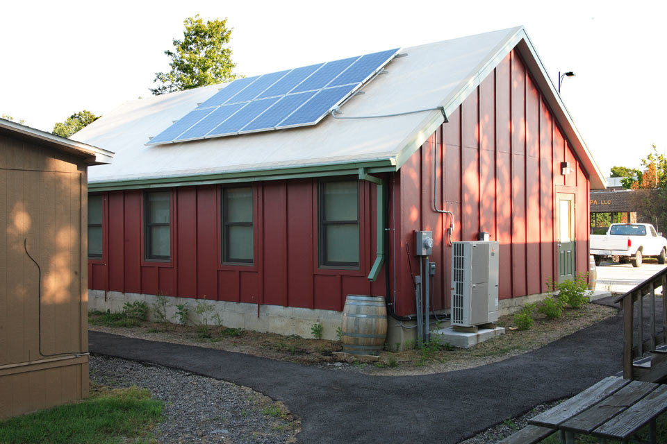 A green school building with solar panels.