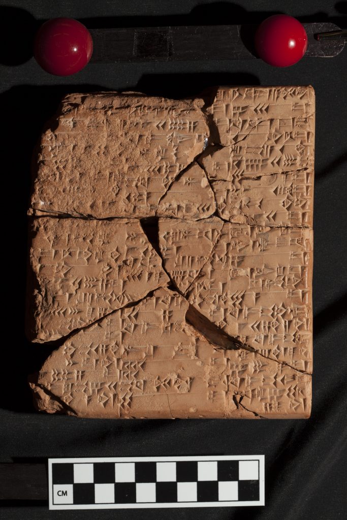 A close up photo of a broken clay tablet