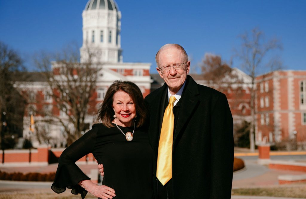 Photo of Gary Coles and Patrica Coles with Jesse Hall in the background.