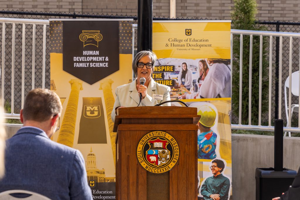 A person speaking at a podium.