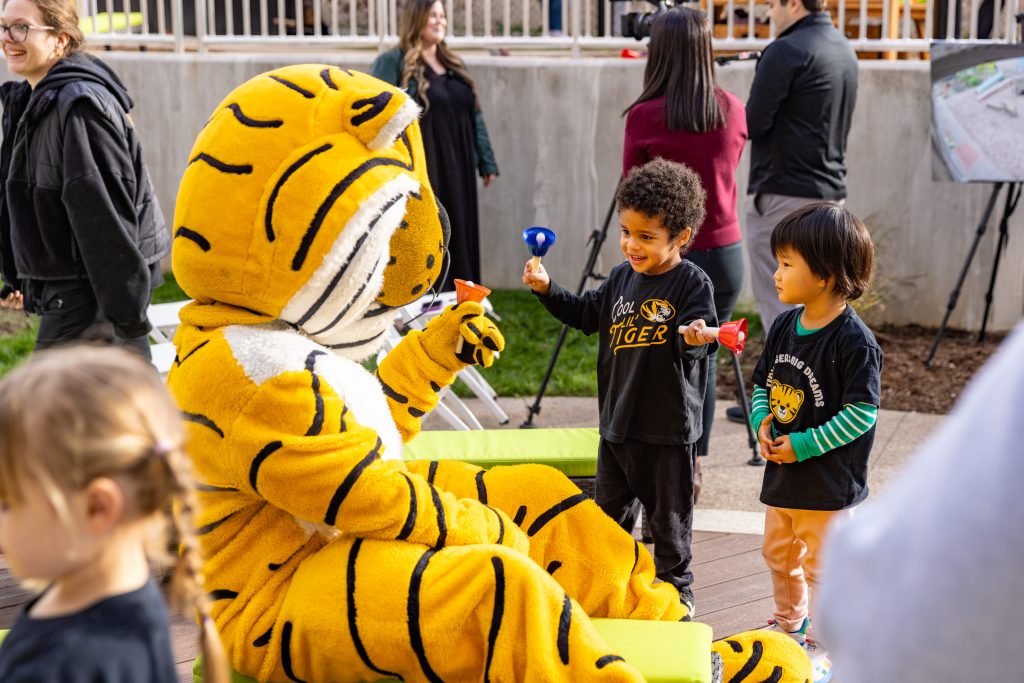 Truman playing with two children.