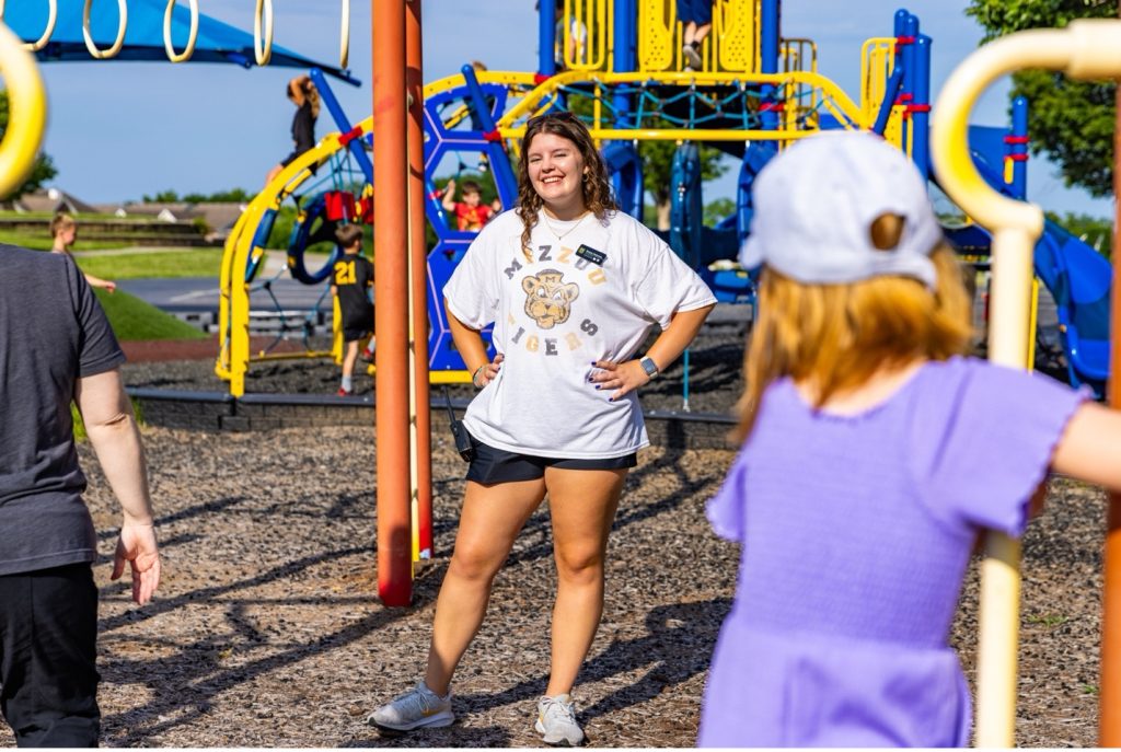 Site leader smiling on the playground