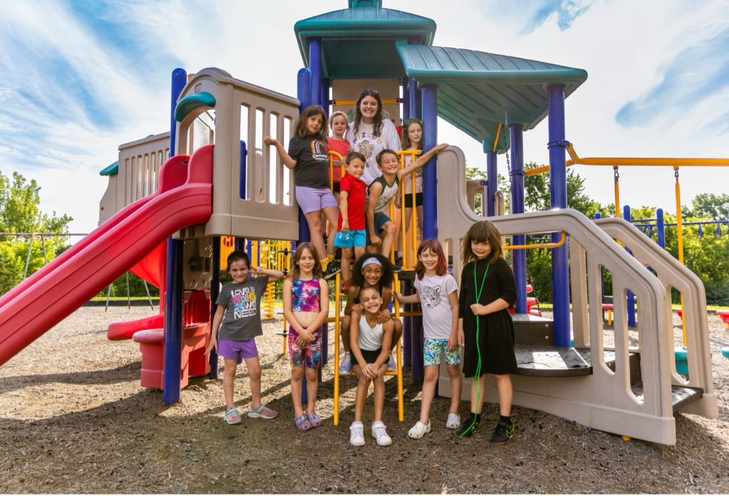 A group of students and a site leader on the playground