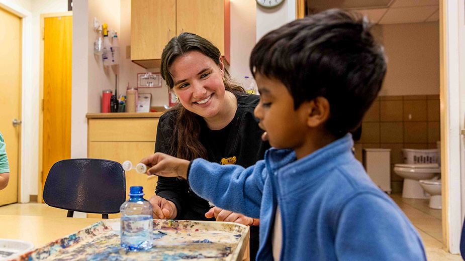Student looking at a child in classroom