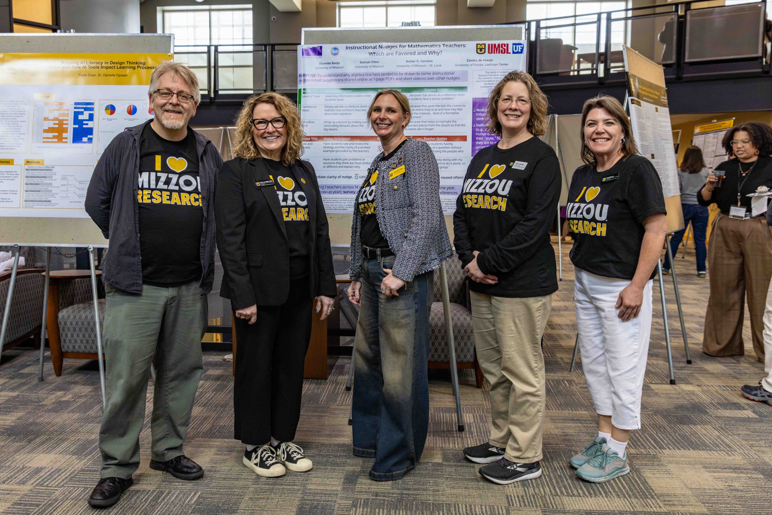 a group of people standing in front of a research poster