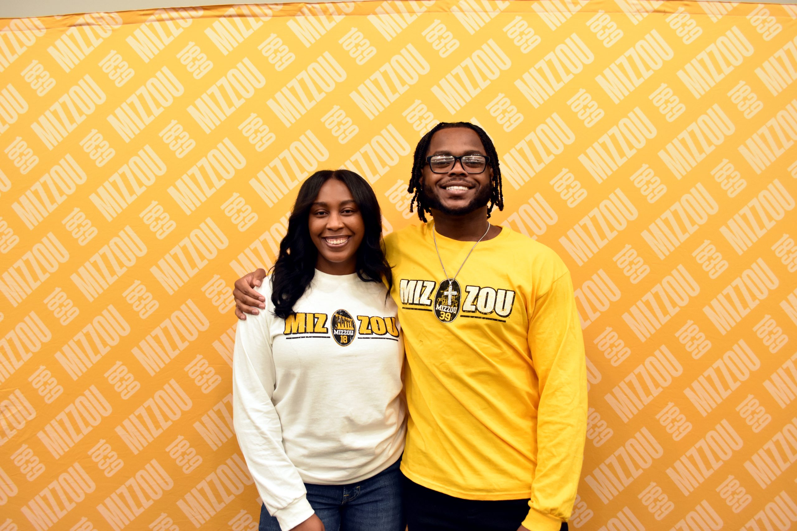 two people smiling and posing for the camera