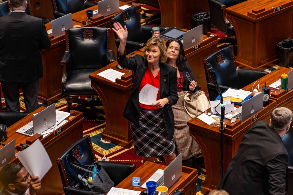 a person waving at the camera