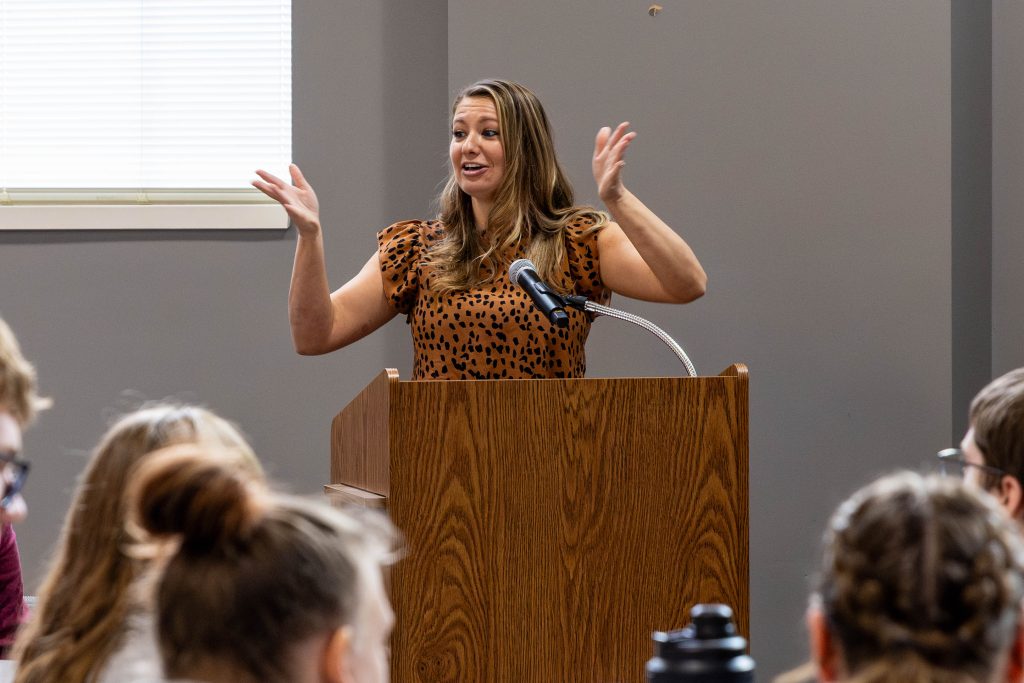a woman speaking behind a podium