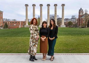 three women smiling for the camera