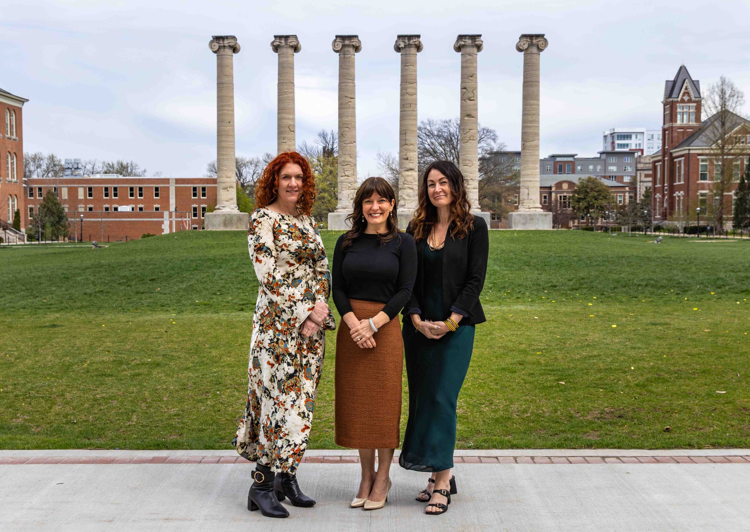 three people smiling for the camera