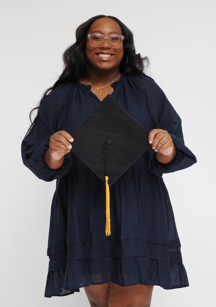Sydney Rushing holding a graduation cap