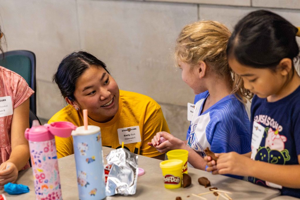 a teacher smiles at a student