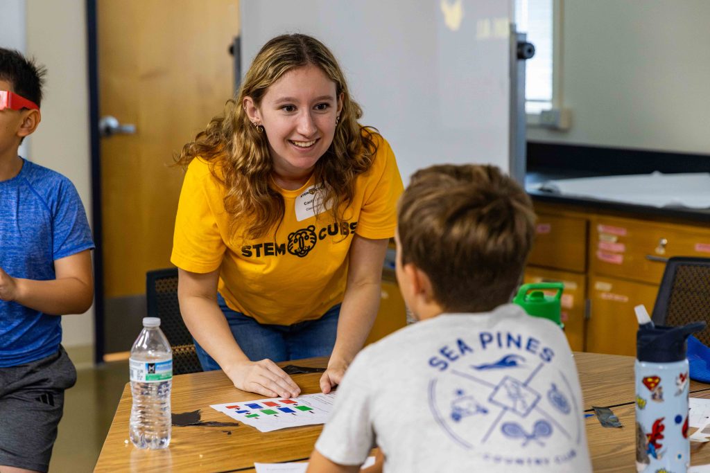 a teacher smiles at a student