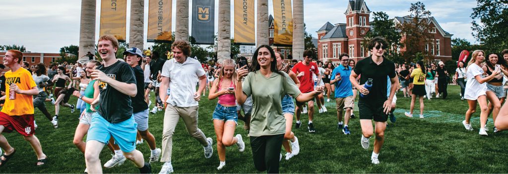 Tiger Walk 2024 students running through the columns