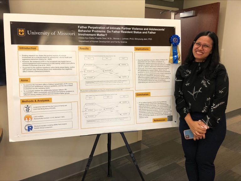 Dwika Dewi an HDFS doctoral student with research poster