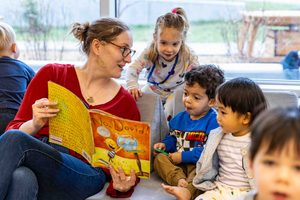 Miranda Clines reads with students at the Child Development Lab