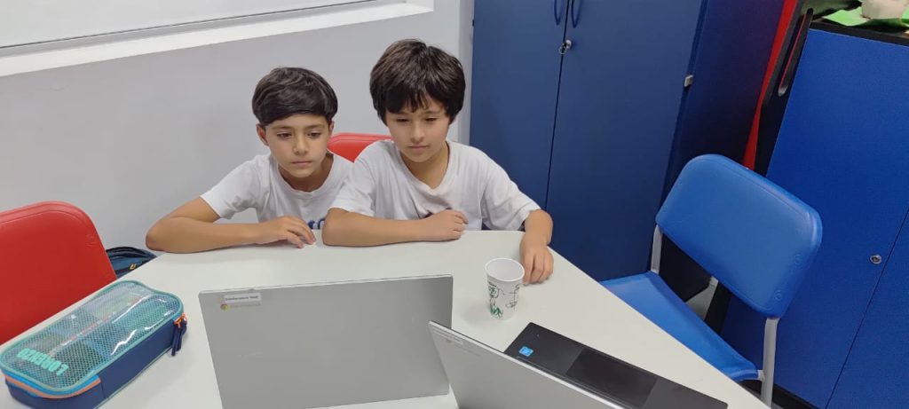 Students using a laptop.